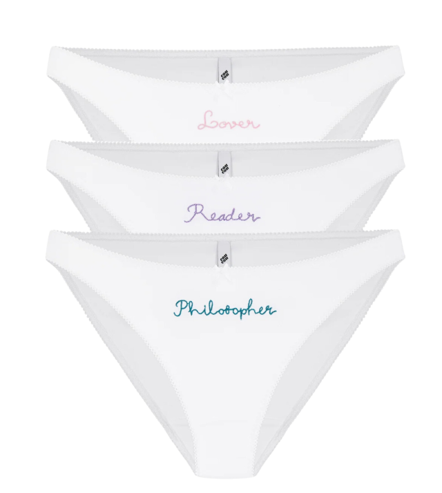 Three white cotton briefs with text.