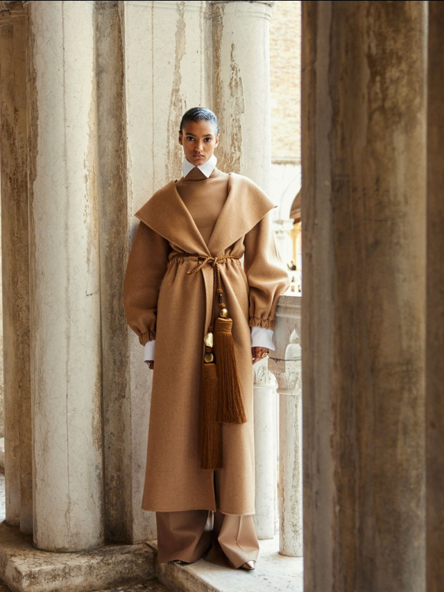 Camel coat, gold tassel.