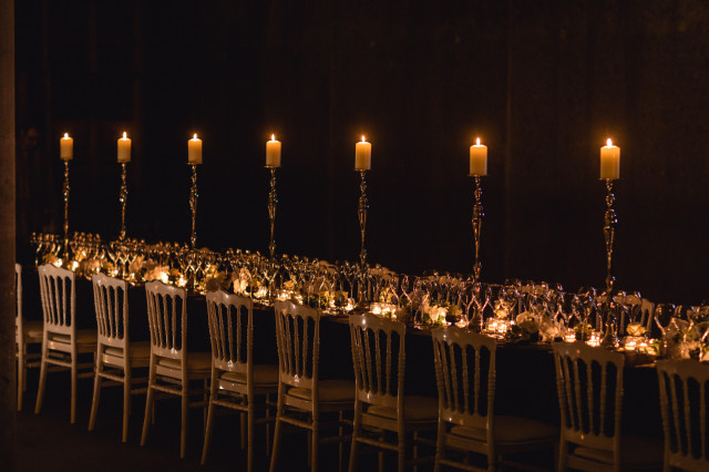 Candlelit table set for formal dinner.
