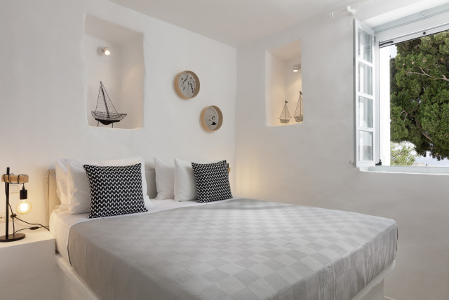 White bedroom with sea view.