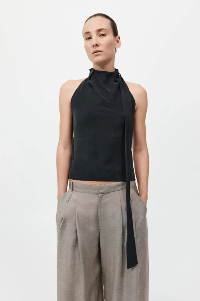 Woman in black halter top and pants.