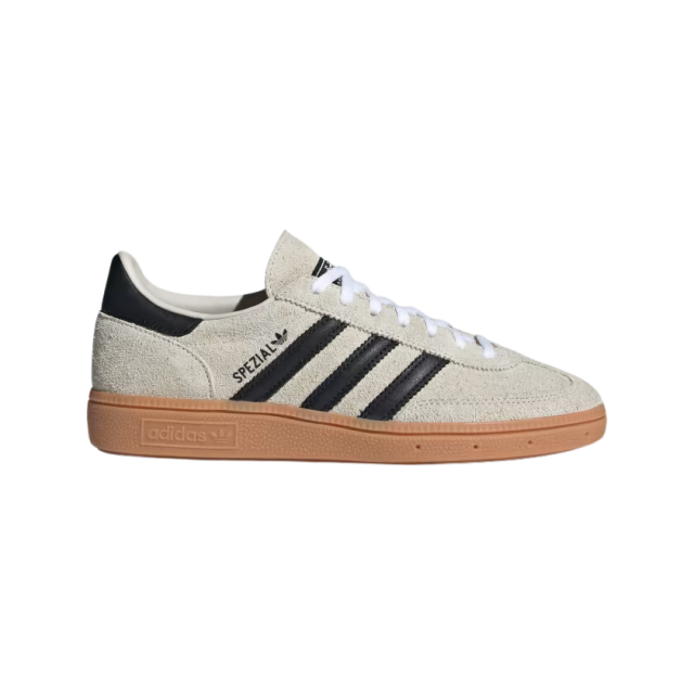 Beige Adidas sneaker with black stripes.