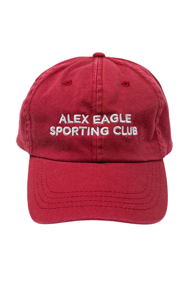A red baseball cap features white embroidered text reading