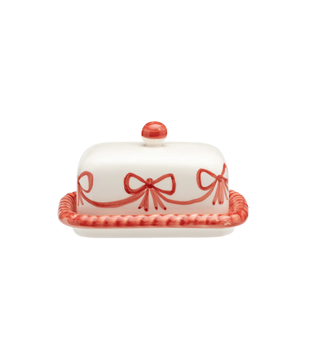 Ceramic butter dish with red bows on a white background.