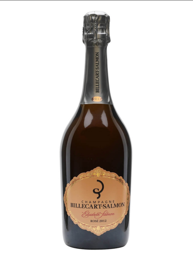 A champagne bottle stands upright, featuring a black label reading