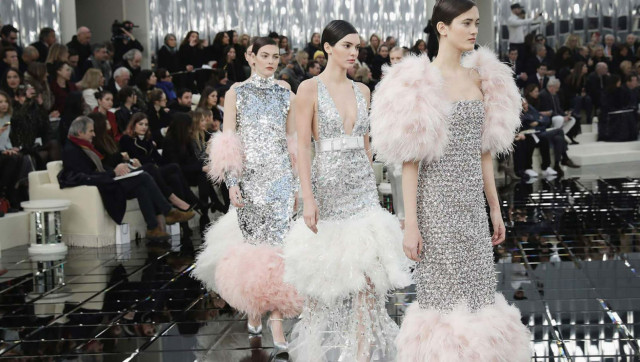 Models in sequined dresses on a runway.