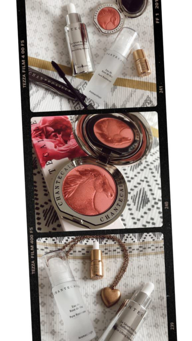 Coral blush compact with a horse emblem among skincare items.