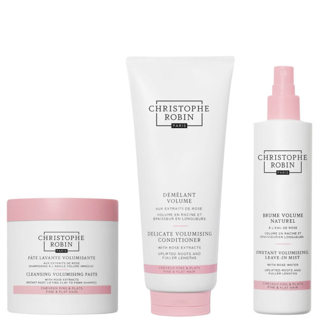 Three Christophe Robin Paris haircare products, including a cleansing paste, volumising conditioner, and leave-in mist, are displayed. They feature white and pink packaging with descriptions in English and French.