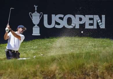 Golfer hitting bunker shot US Open.