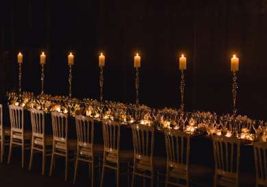 Candlelit table set for formal dinner.