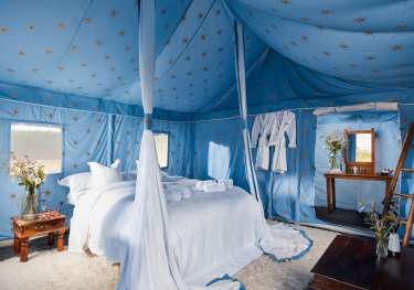 Starry blue glamping tent bedroom.