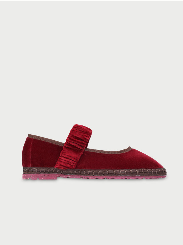 Maroon velvet flat with ruffled strap.