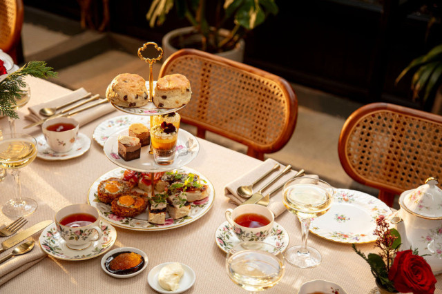 table with afternoon tea spread and wicker chairs