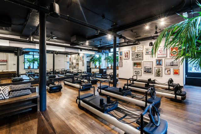 Pilates reformers in spacious studio.