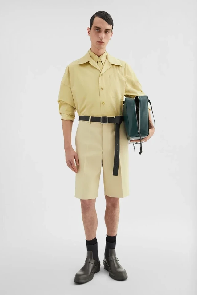 Man in yellow shirt and shorts.
