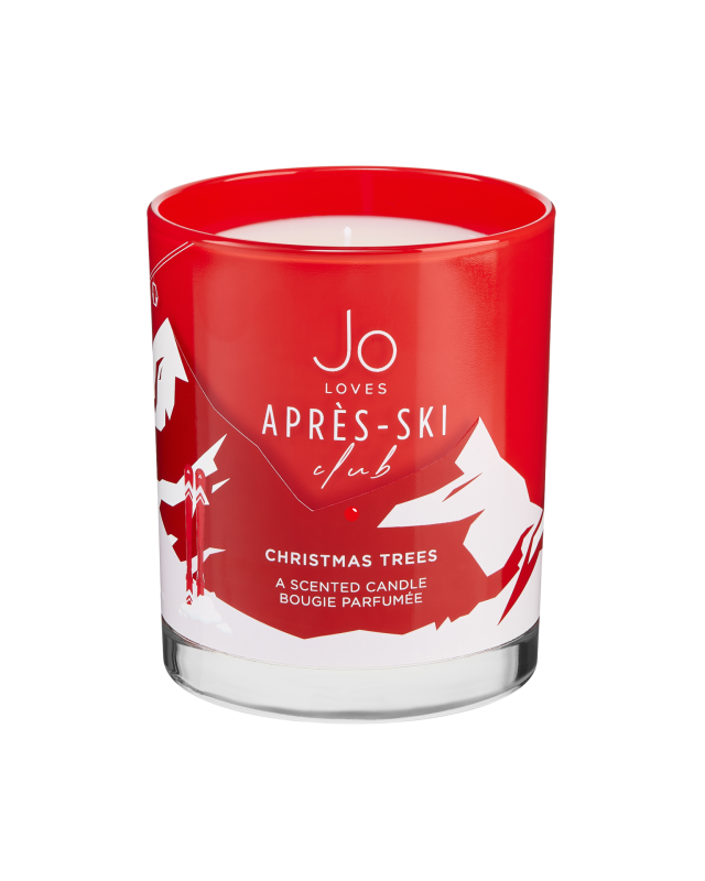 A red glass candle holder with white abstract designs contains a white candle. Inscription reads:
