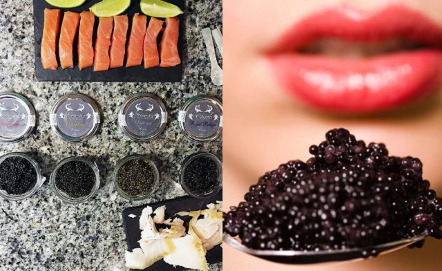 Sliced salmon and lime are arranged on a granite countertop beside jars of various caviar