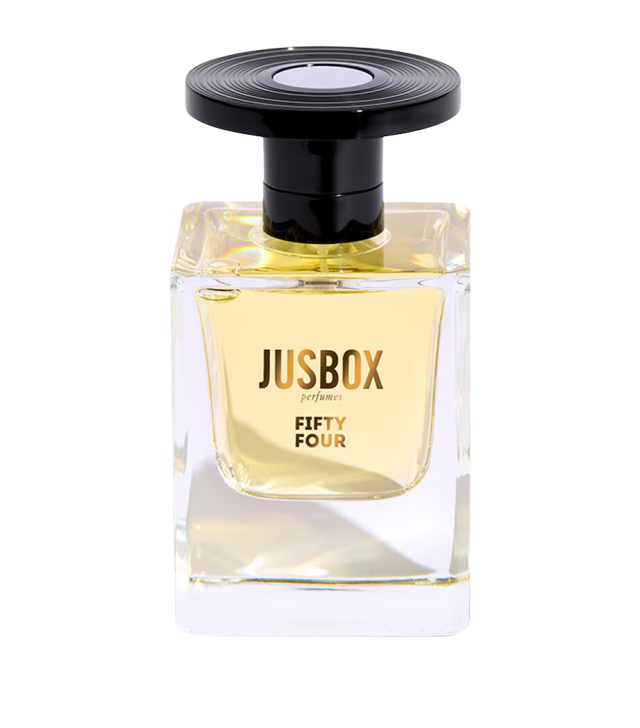 Perfume bottle, containing light amber liquid, topped with a black circular cap. The label reads 