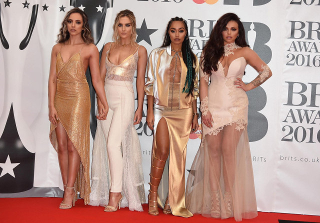 Women posing on the BRIT Awards 2016 red carpet.