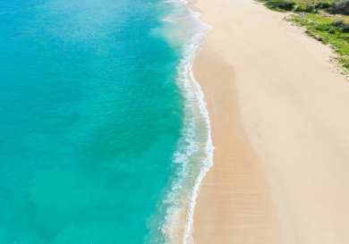 Pristine white sandy beach .