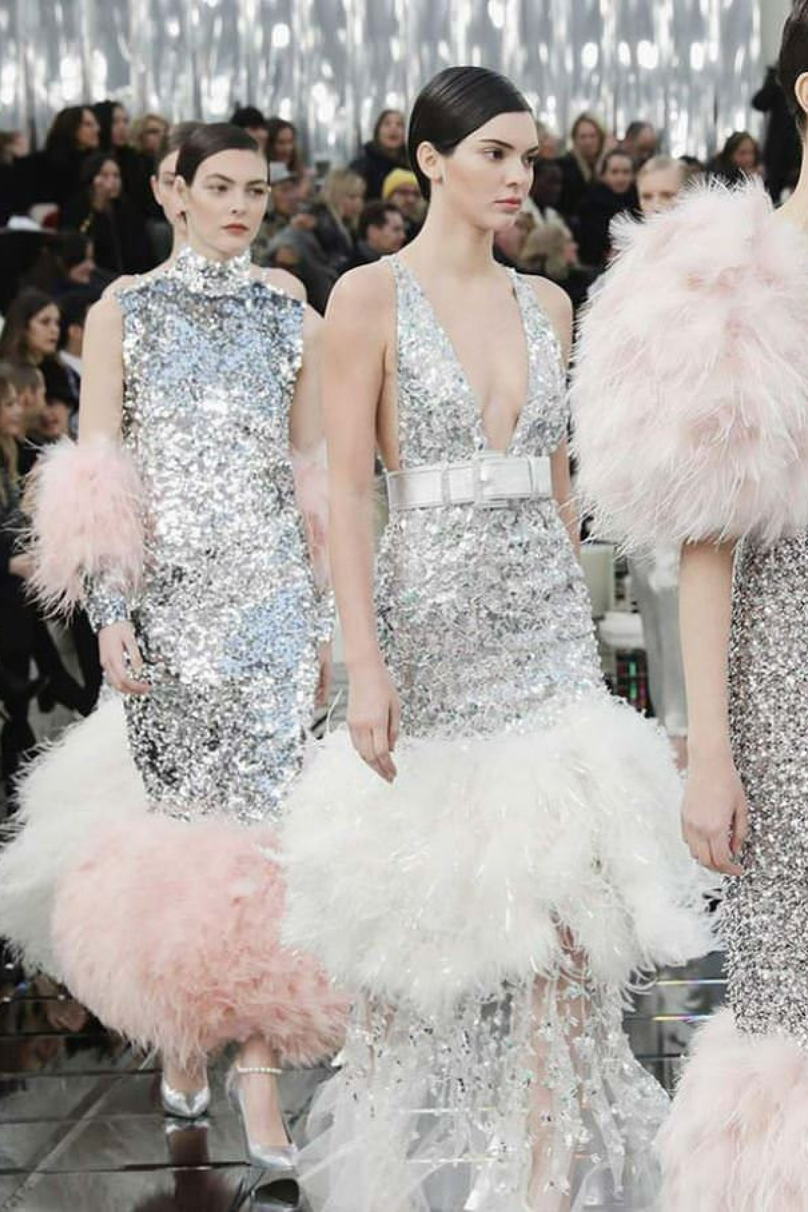 Models in sequined dresses on a runway.