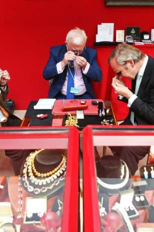 Event exhibitors get ready for the opening of the art & antiques fair.