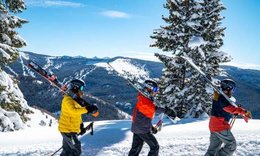 Skiers climbing mountain.