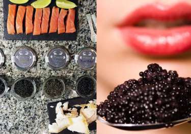 Sliced salmon and lime are arranged on a granite countertop beside jars of various caviar.