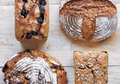 Four loaves of bread, including sourdough and fruit loaves.