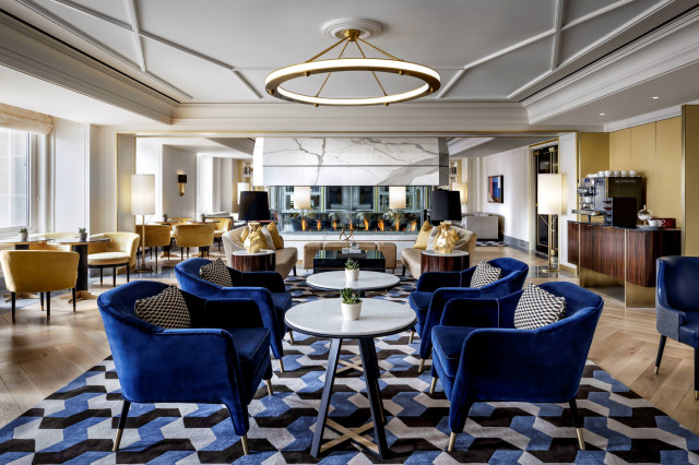Blue velvet chairs and tables in a luxurious lounge.
