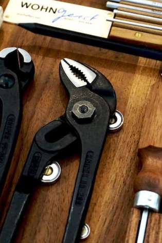 Tools are neatly arranged in a wooden case.