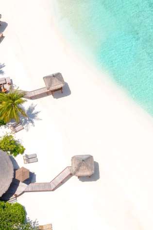 Timeless luxury at banyan tree vabbinfaru beach ocean huts.