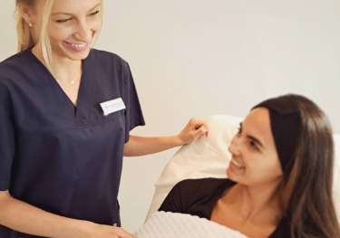 Vicky dondos with a patient.
