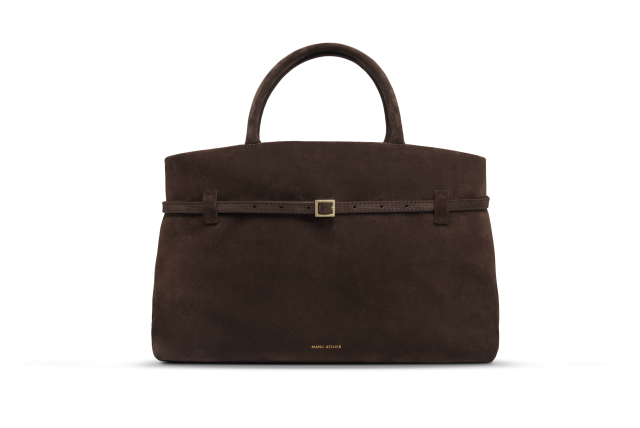 Brown suede handbag with buckled strap.