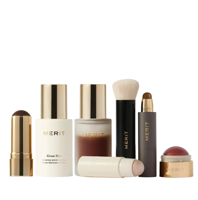 Makeup products are neatly arranged, including foundation sticks, a white moisturizer bottle labeled