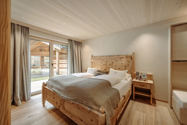 Wooden bedroom with patio view.