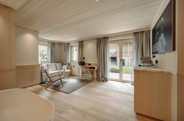 Spa-like suite with wood floors.