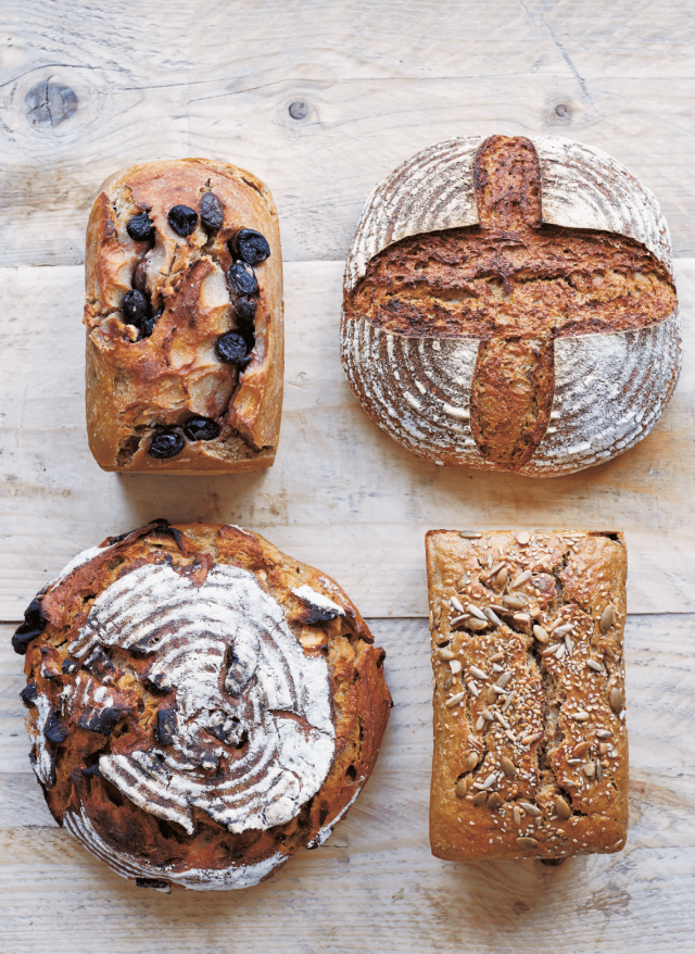 Four loaves of bread, including sourdough and fruit loaves.
