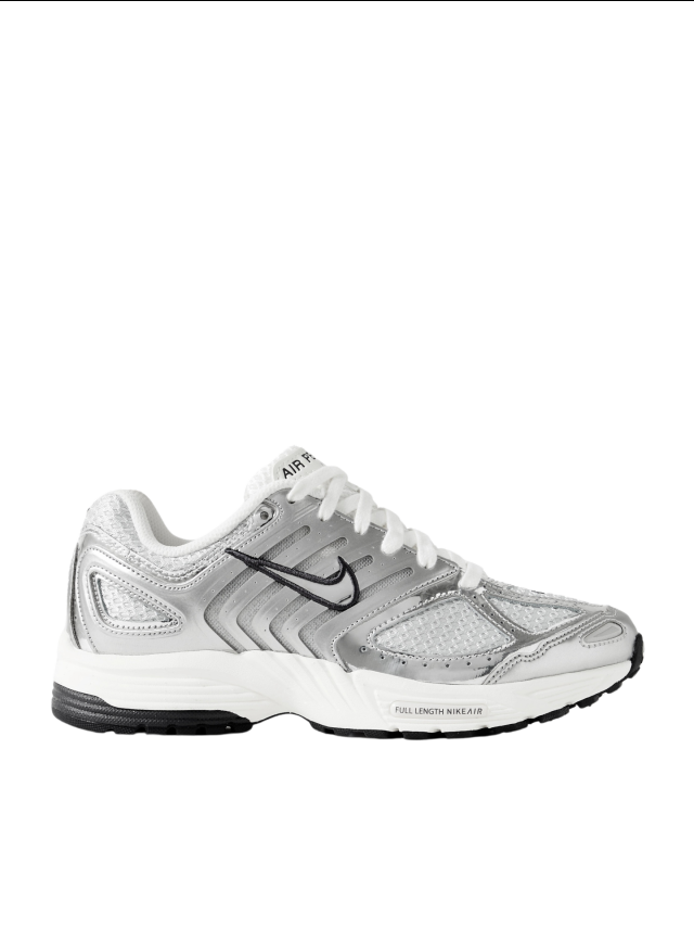 A white and silver Nike sneaker with black accents, featuring a mesh design, lace-up closure, and text saying