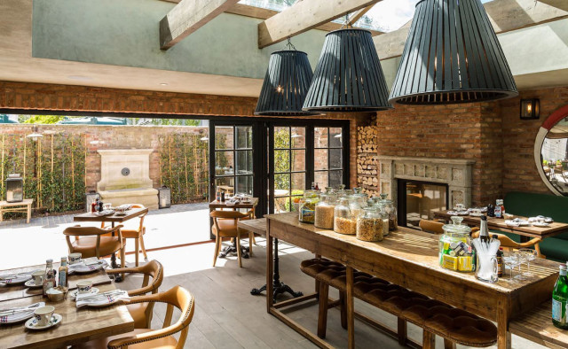 Wooden table with food in a brick-walled restaurant.