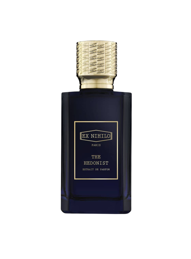 A dark blue perfume bottle with a textured gold cap displays the text: 