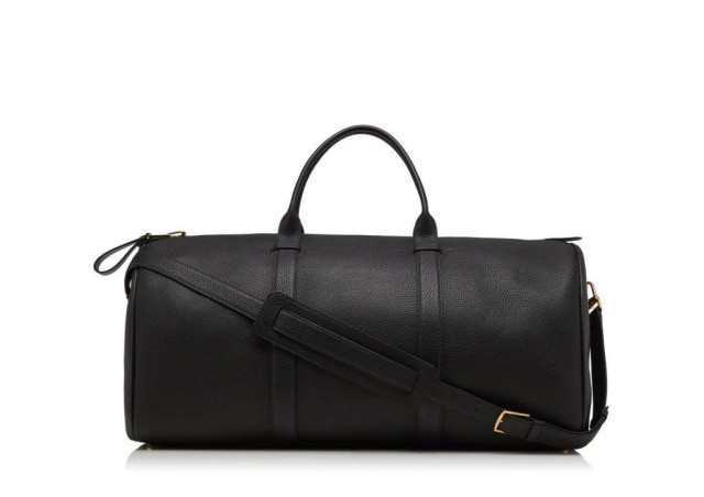Black leather duffel bag on white background.