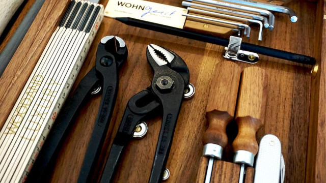 Tools are neatly arranged in a wooden case