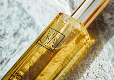 A rectangular glass bottle labeled